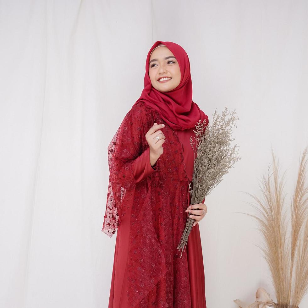 hermosa modelo de mujer islámica que lleva la moda hijab, un traje de estilo de vida moderno para la mujer musulmana. concepto un vestido de novia, belleza o eidul fitri. Una modelo de niña asiática con hiyab en sesión de fotos en interiores