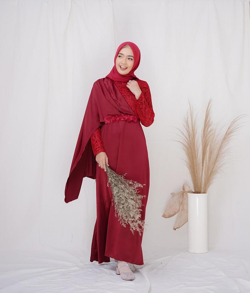 Beautiful islamic female model wearing hijab fashion, a modern lifestyle outfit for muslim woman. Concept a wedding dress, beauty or eidul fitri. A asian girl model wearing hijab on indoor photoshoot photo