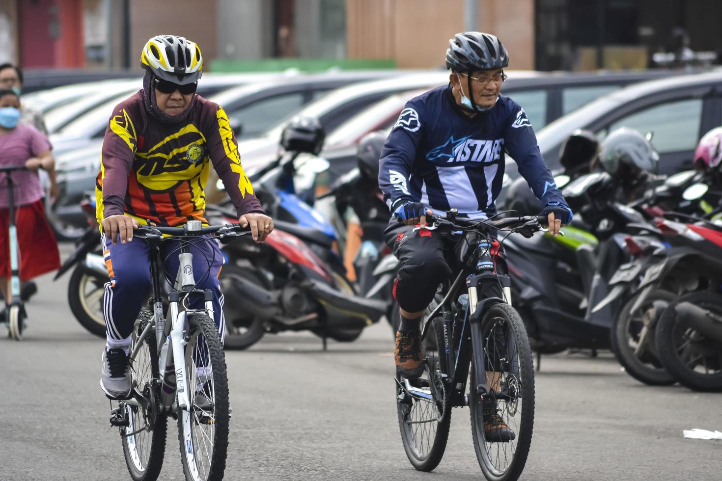 Bekasi, West Java, Indonesia, March 5th 2022. People exercising bicycles in city park on saturday photo