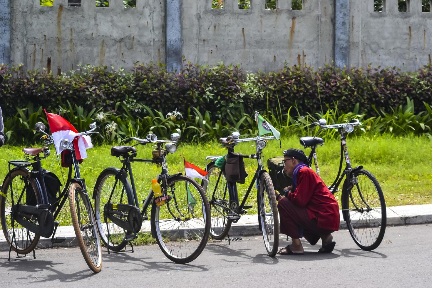 Bekasi, West Java, Indonesia, March 5th 2022. An old style javanese cleaning antique bicycle photo