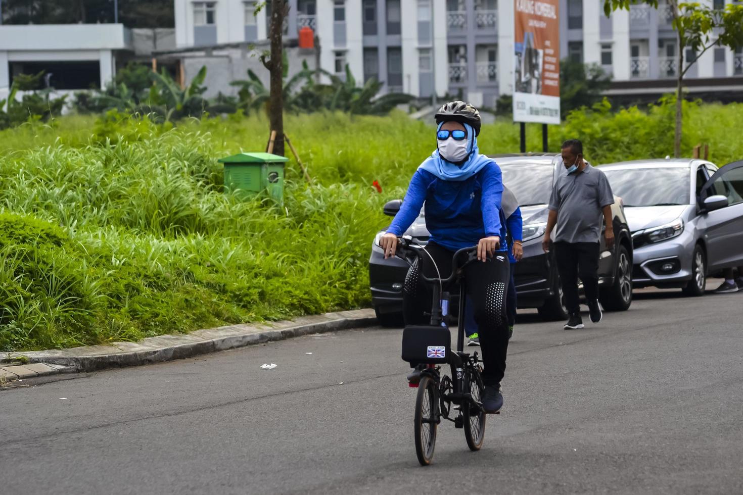 Bekasi, West Java, Indonesia, March 5th 2022. People exercising bicycles in city park on saturday photo