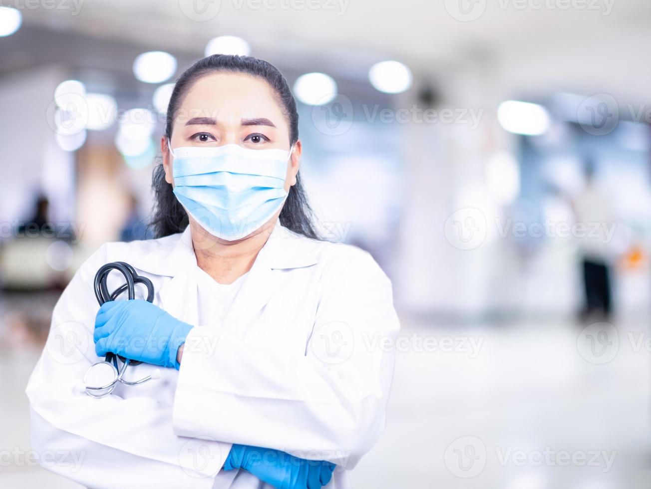 Woman doctor stands in front of an examination room in a hospital. concept of medical treatment health care annual health check Beauty, Research, Lab, Science, closeup, copy space, blurred background photo