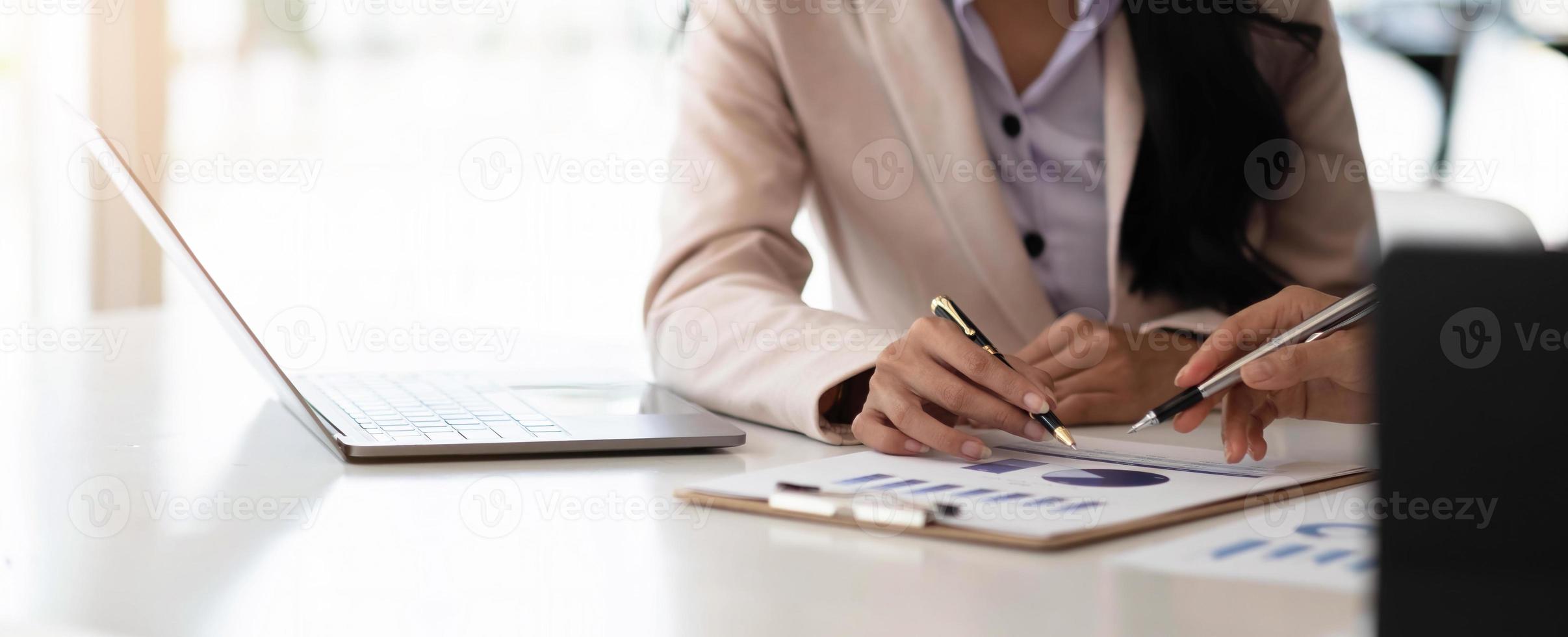 Business people meeting to find analytical ideas pointing to the graph at the office. photo