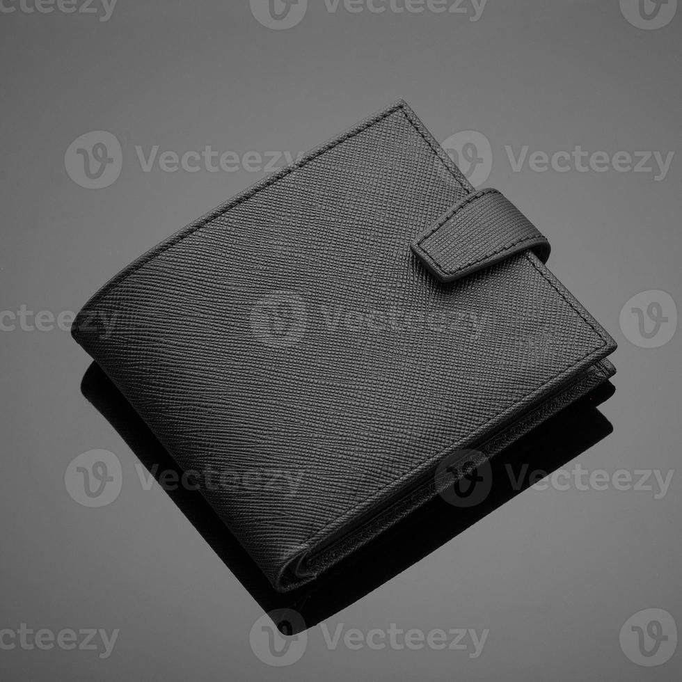 Fashionable designer leather men's wallet on a black background photo