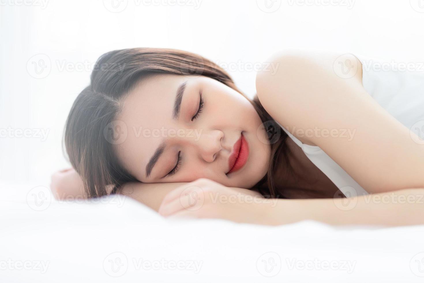 Image of young Asian woman in bed photo