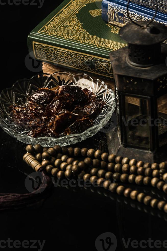 prayer beads with date palm on black background photo