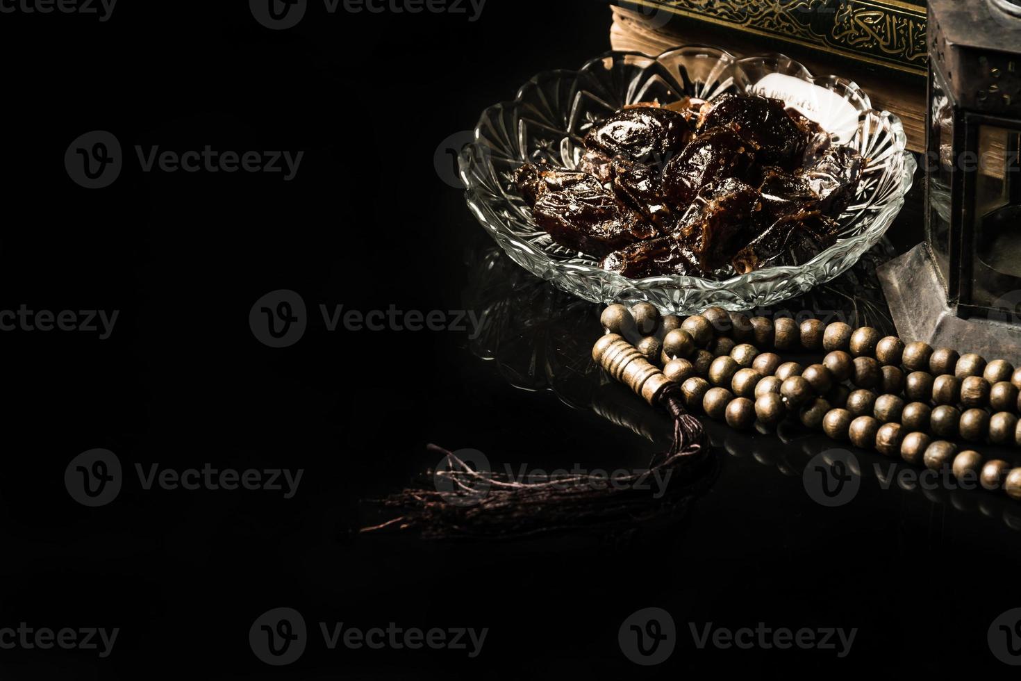 prayer beads with date palm on black background photo