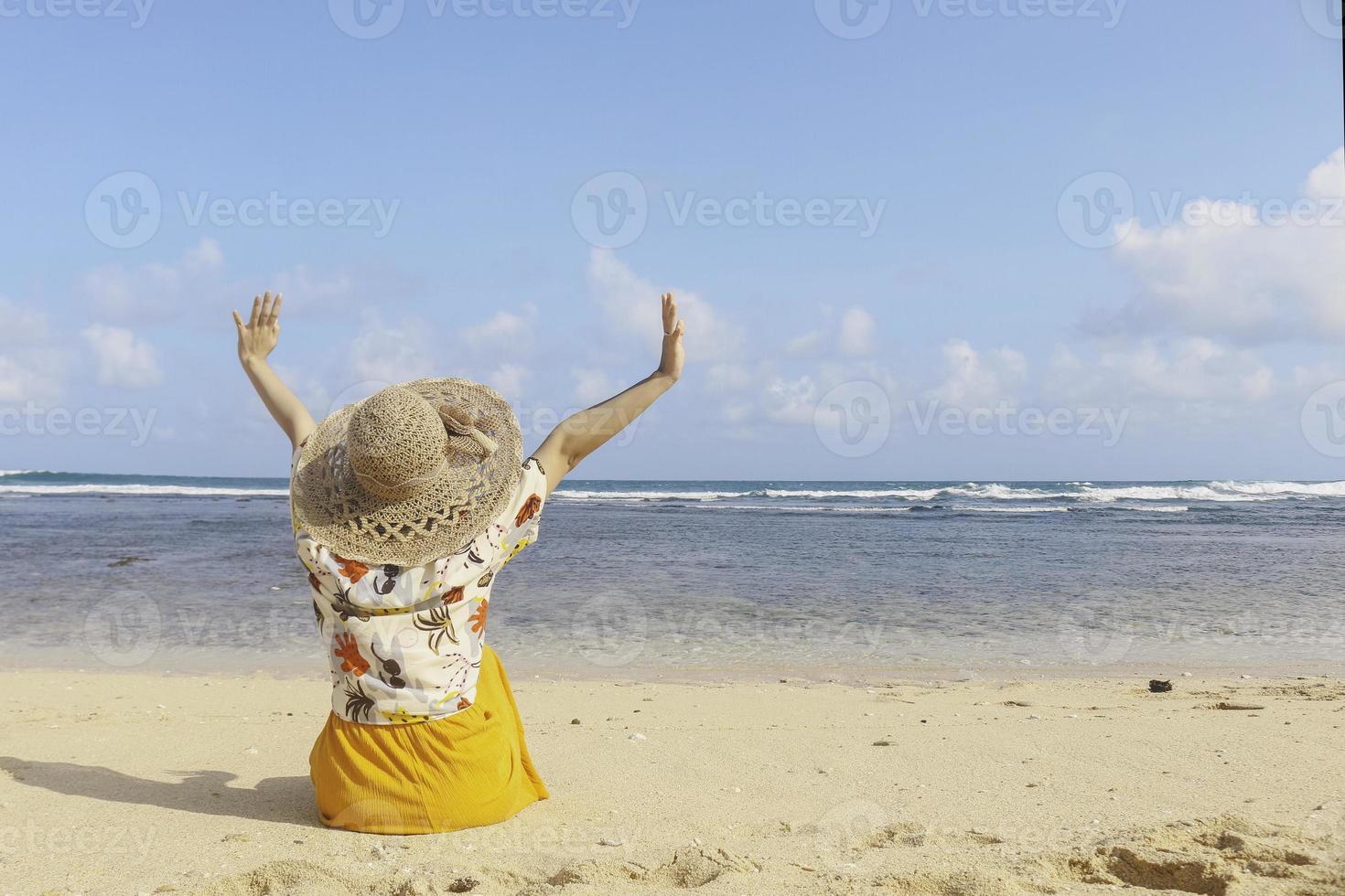 Portrait of happy smiling Asian woman enjoys a holiday at the beach. photo