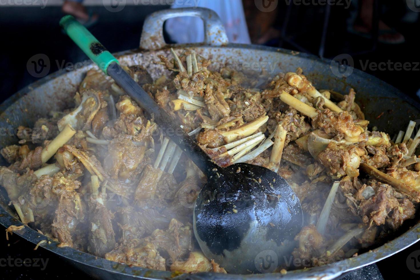 Cooking Tengkleng in big pan. goat meat with ribs and bone cooked with soup. Indonesian Traditional Food made from Barbecue Lamb's Bone. photo