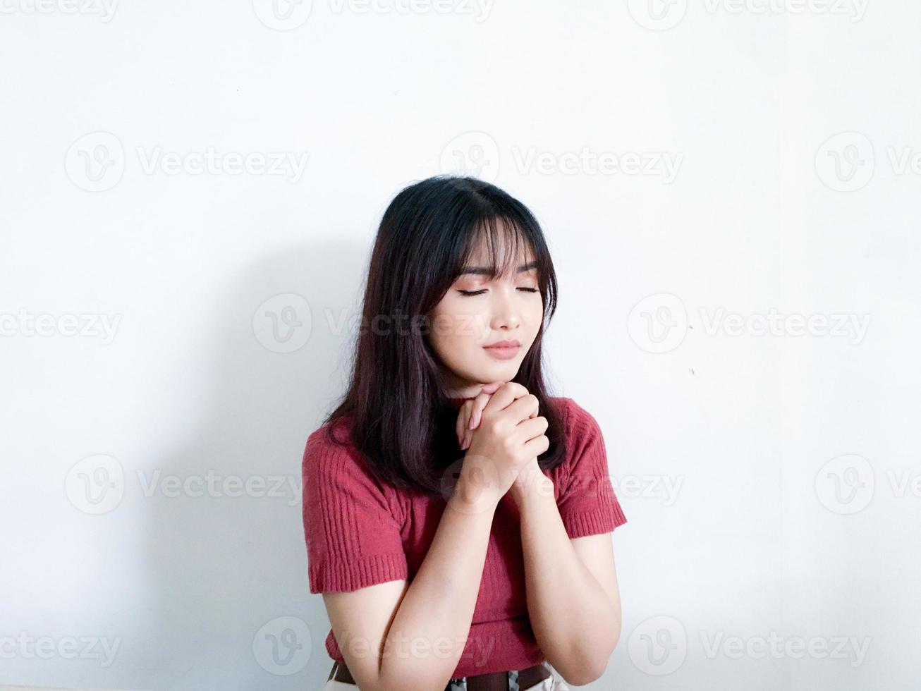 Happy beautiful asian girl wearing red sweater praying to god, Christmas concepts, Winter concepts , isolated on white background. photo
