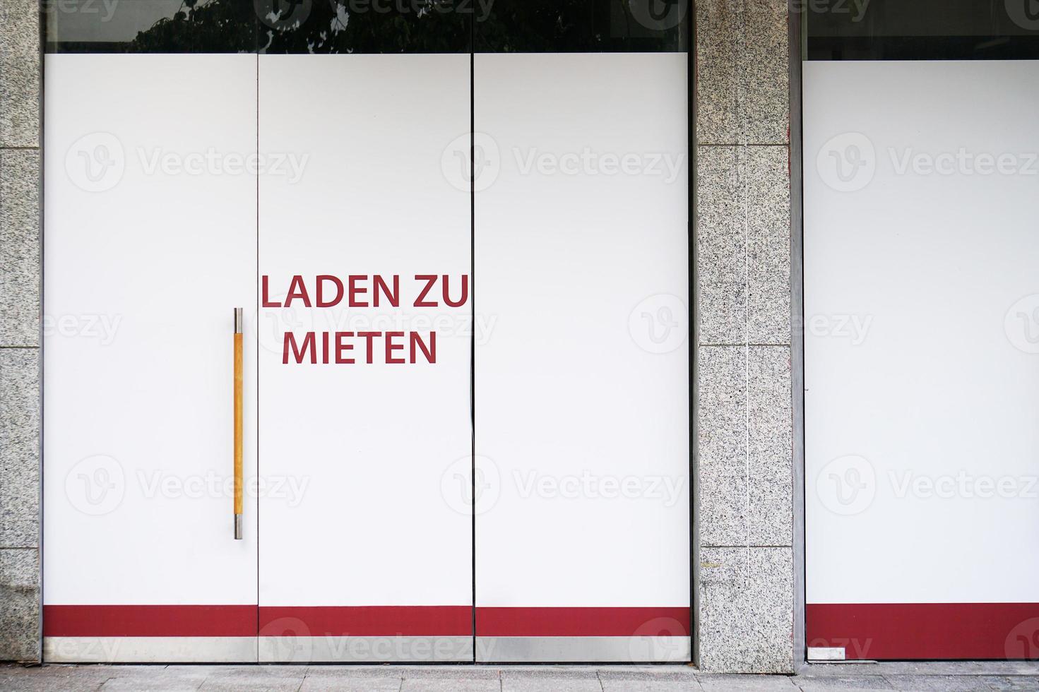 German vacancy sign on storefront - Laden zu mieten means store to let photo