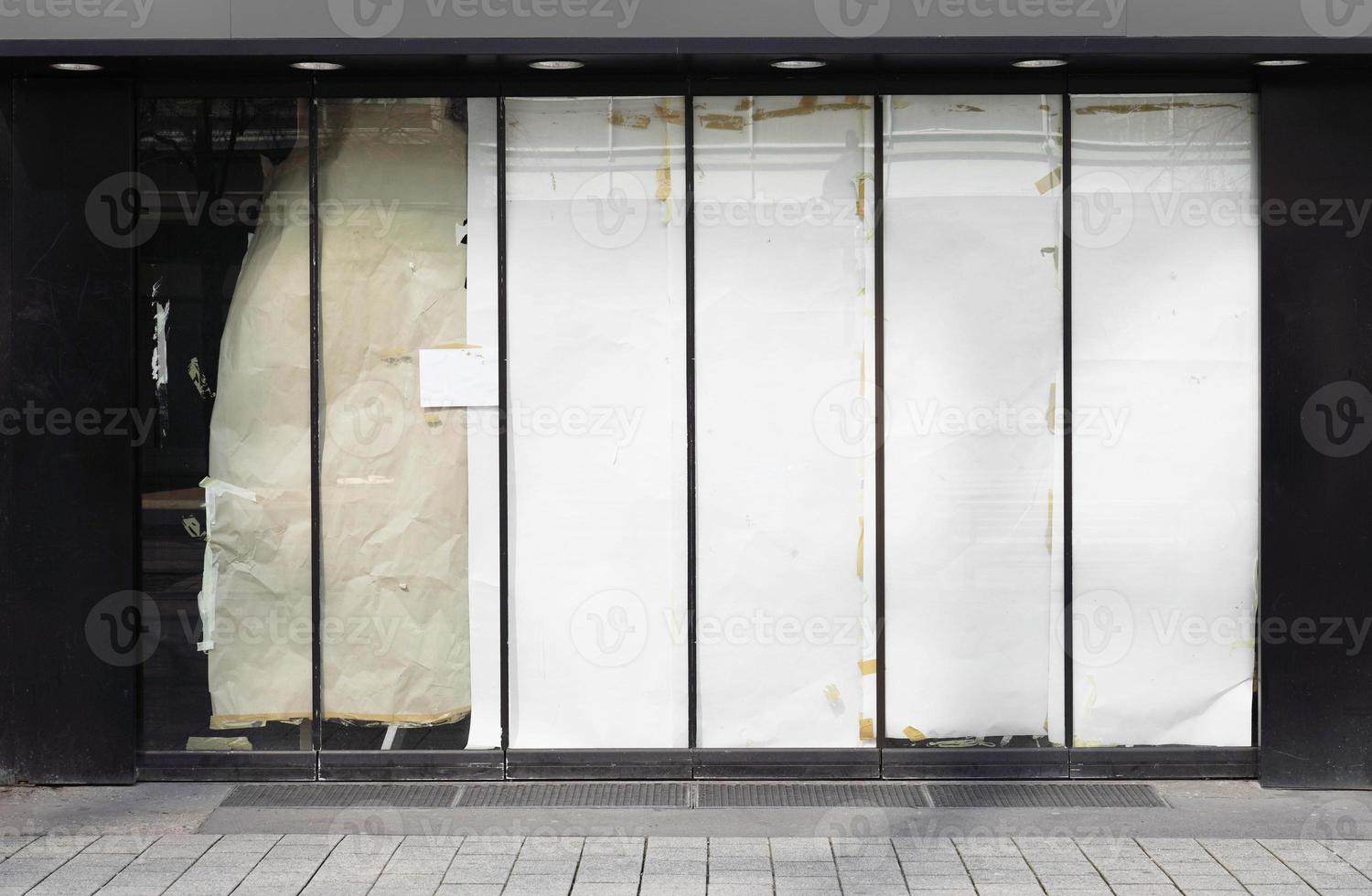 closed or empty shop or store storefront with blocked windows photo