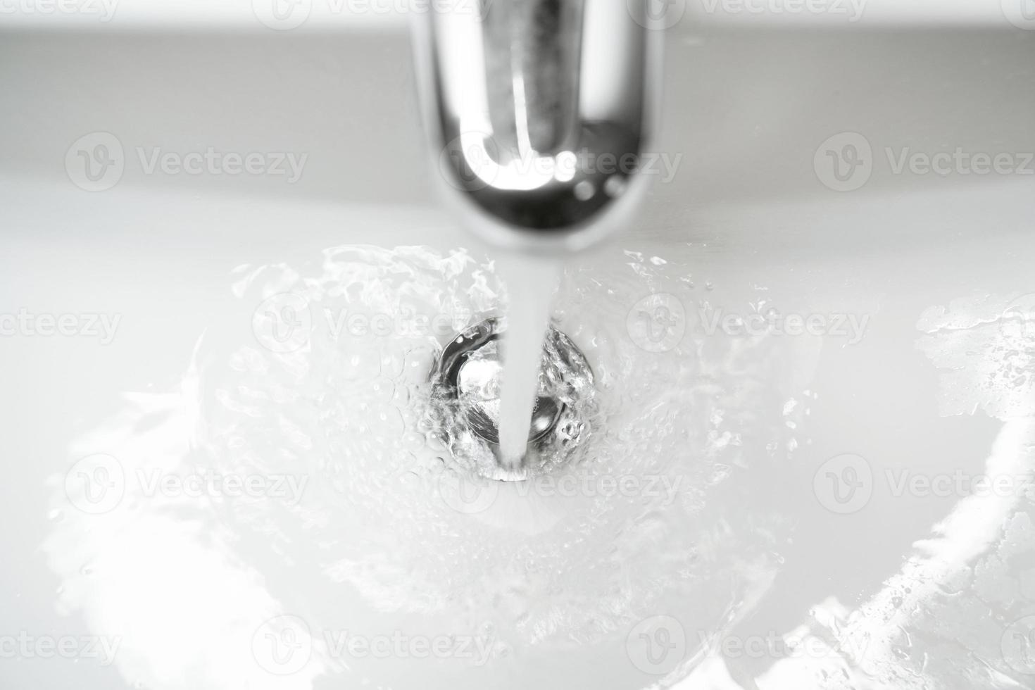 bathroom sink or hand basin with running water photo