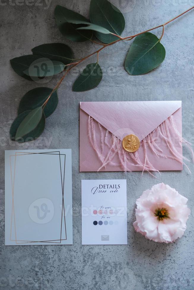 wedding invitation in a gray envelope on a table photo