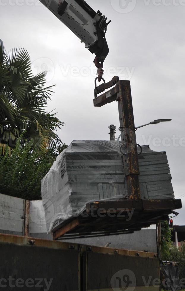 loading or unloading of stone tiles photo