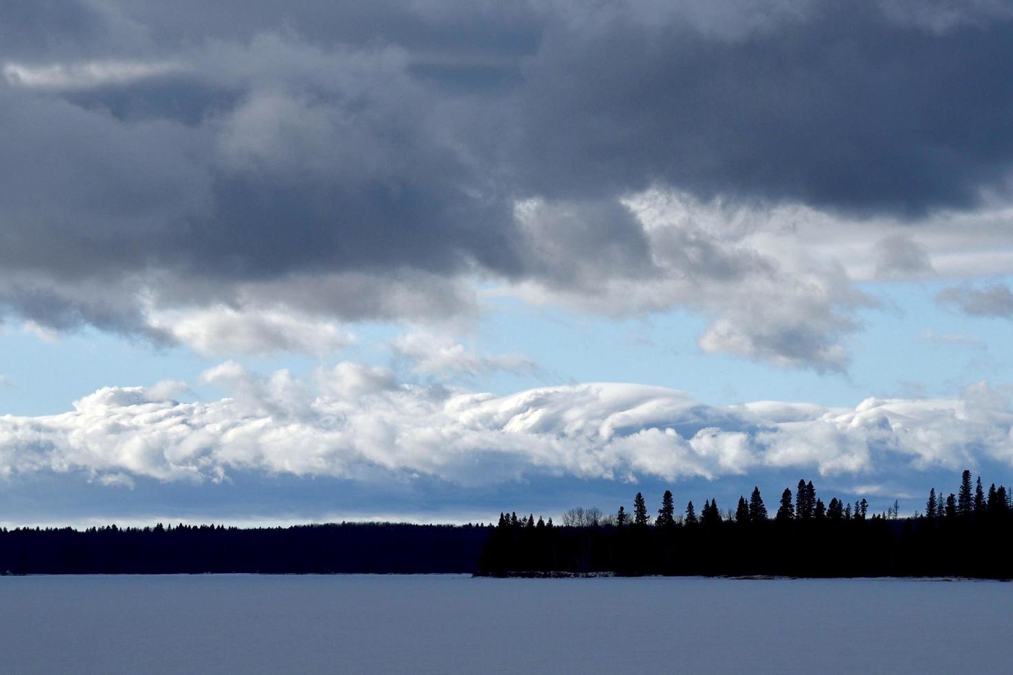 a winter storm front over a frozen lake photo