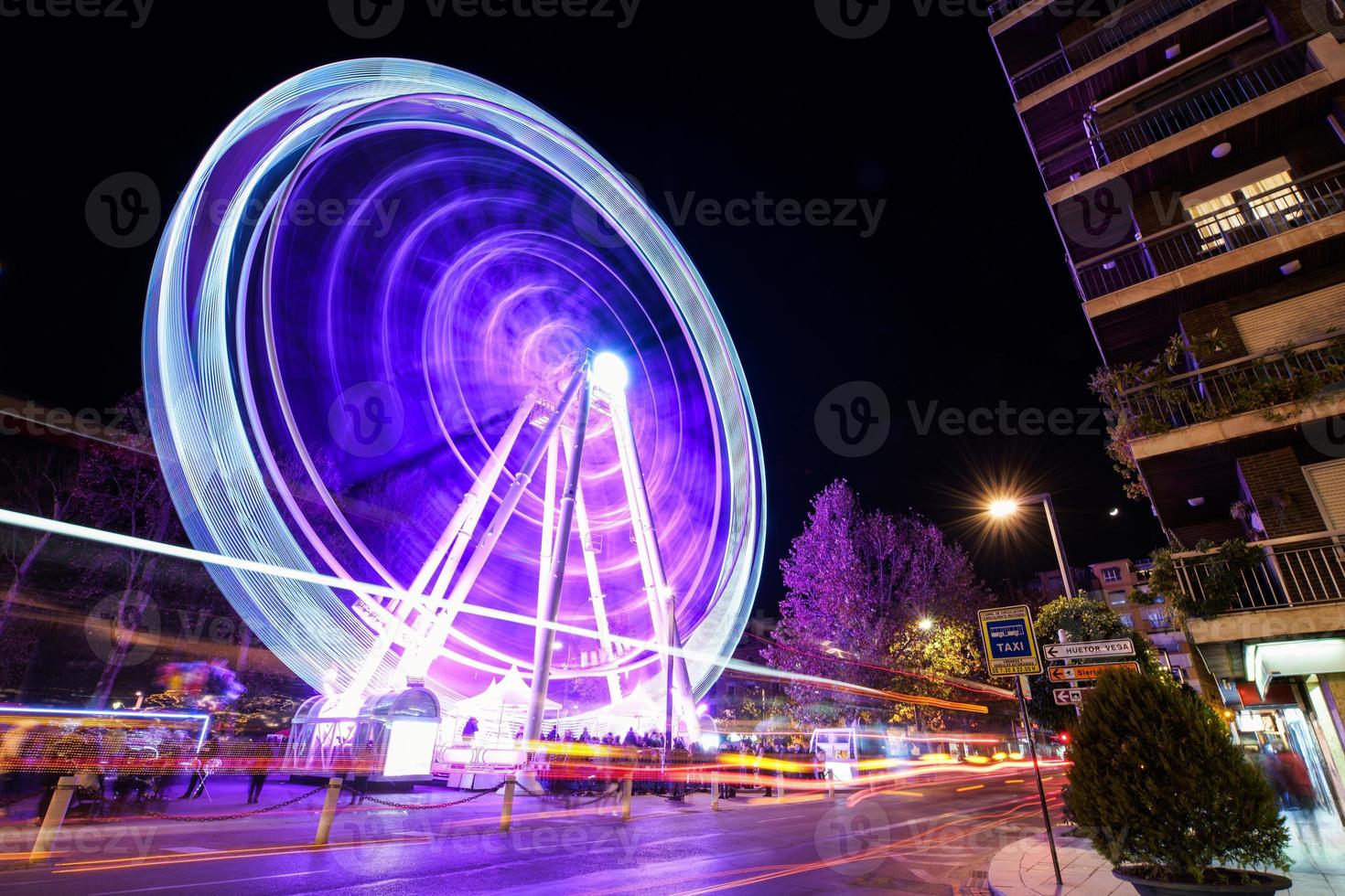 Ferris wheel at night at the fair in Granada. photo