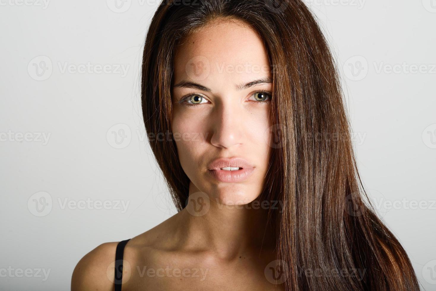 Beautiful young woman without make-up on white background photo