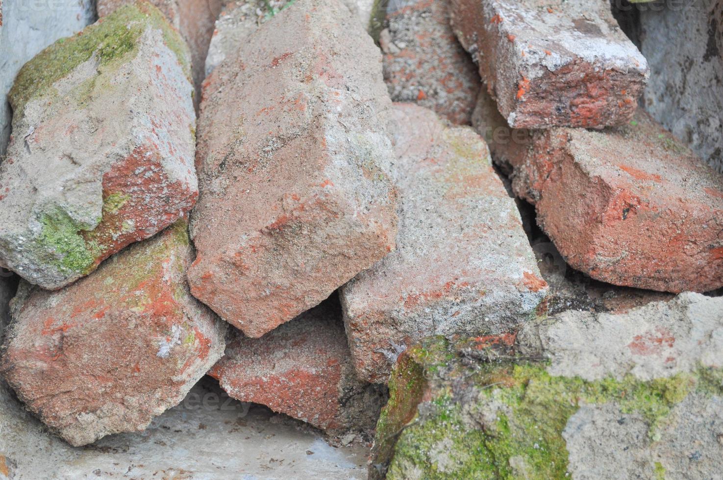 Old red bricks for wall construction photo