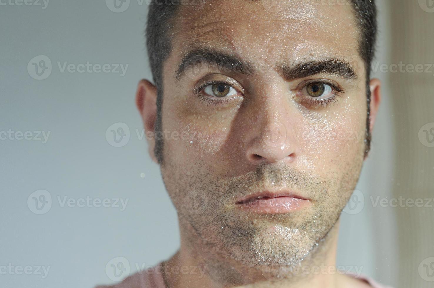 Closed portrait of a man with water drops photo