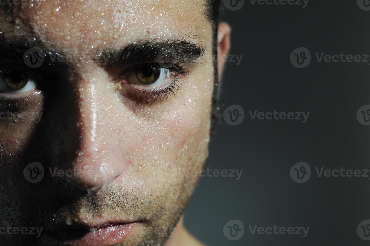 Closed portrait of a man with water drops photo