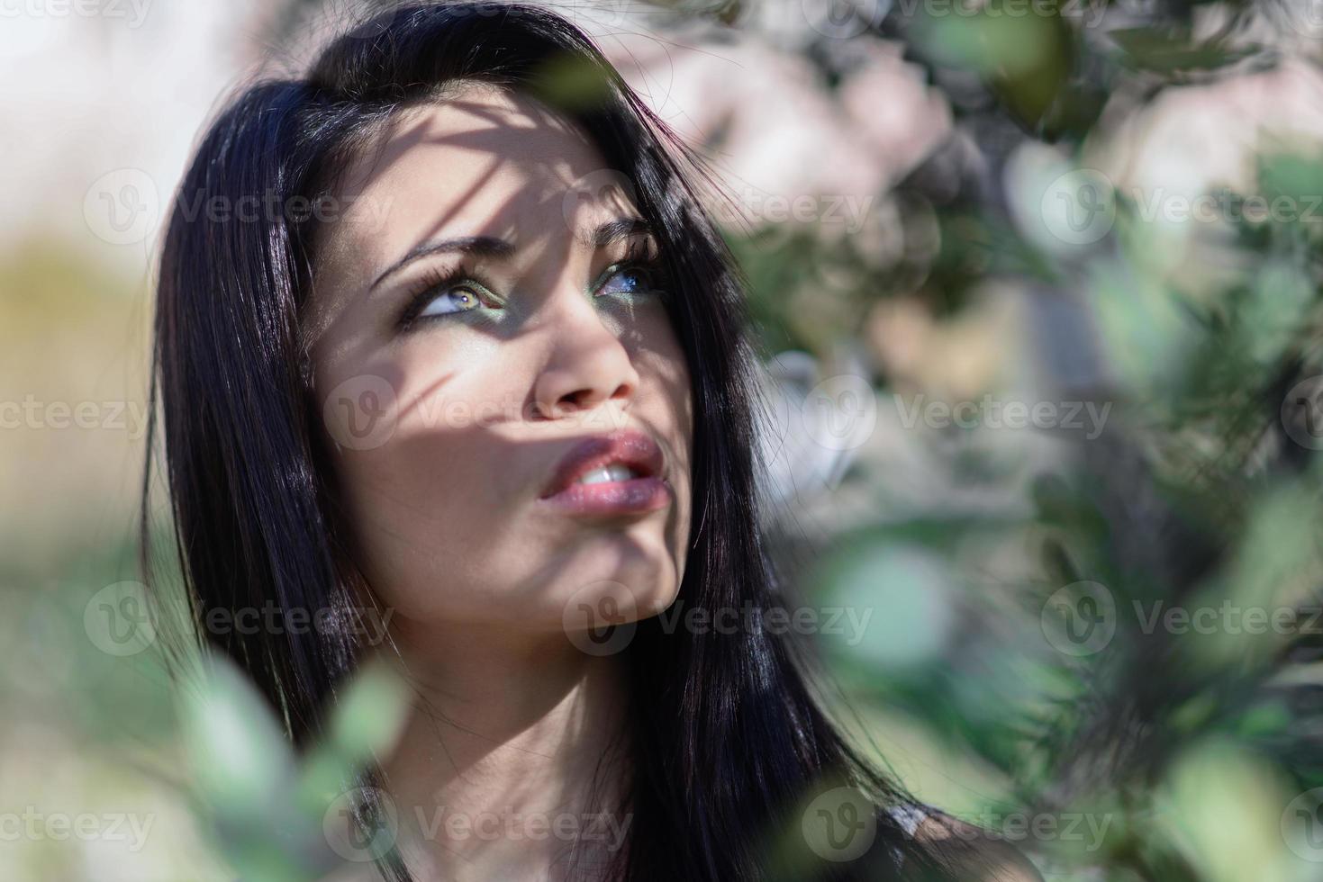 Young woman with green eyes in urban park photo