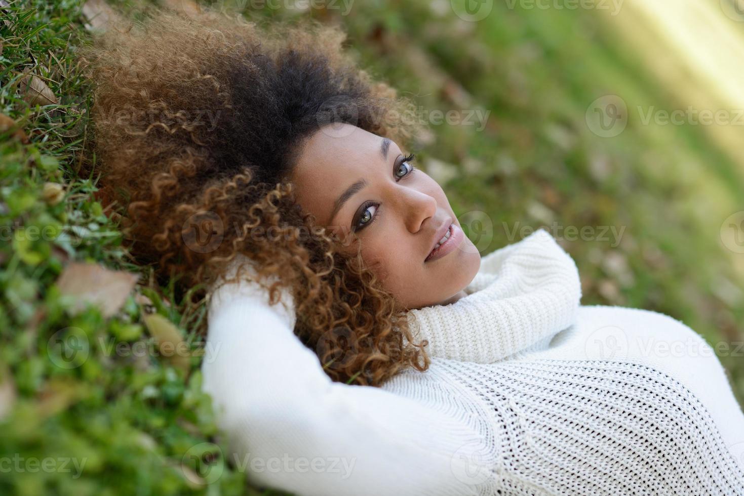 Young African American girl with afro hairstyle and green eyes photo