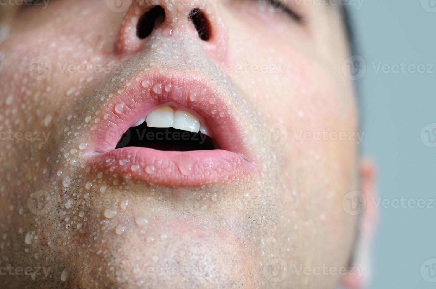 Closed portrait of a man with water drops photo