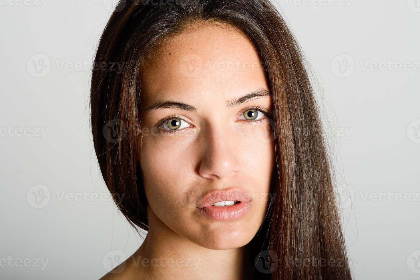 Beautiful young woman without make-up on white background photo