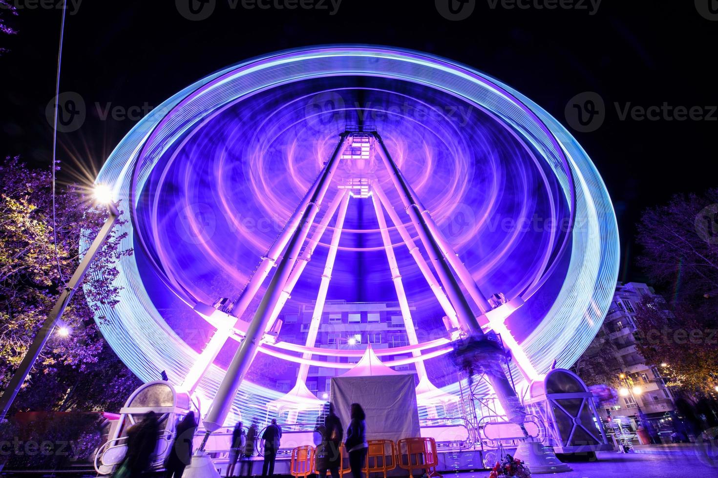 Ferris wheel at night at the fair in Granada. photo