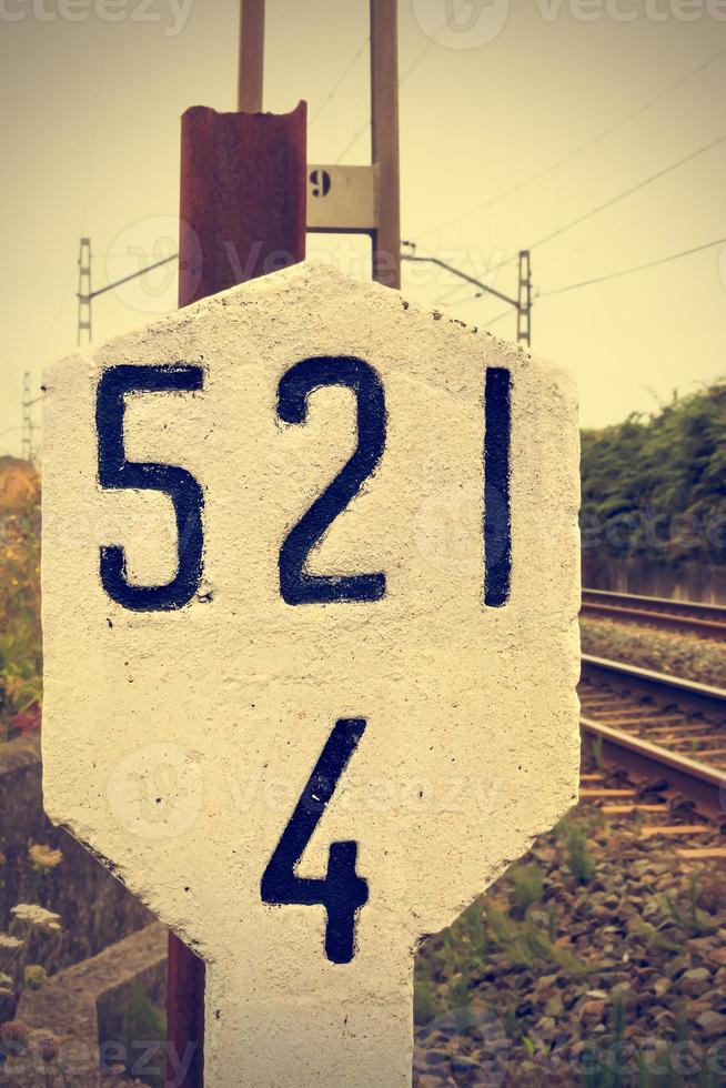 Stone signal in the railway line. Retro vintage style. Vertical image. photo