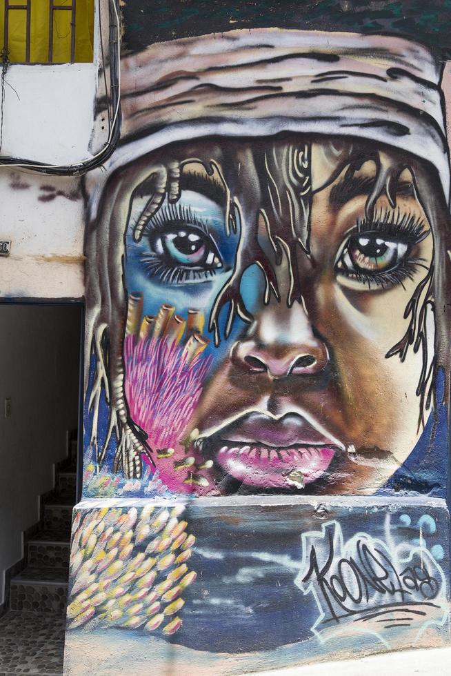 Medellin, Colombia, 2019 - Street art of Comuna 13 in Medellin. Once known as Colombias most dangerous barrio, today graffiti tour is one of most popular tourist attractions in Medellin. photo