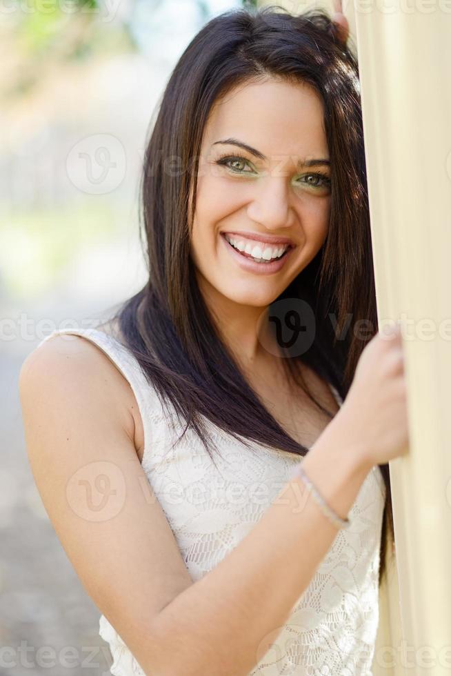 Young woman with green eyes in urban background photo