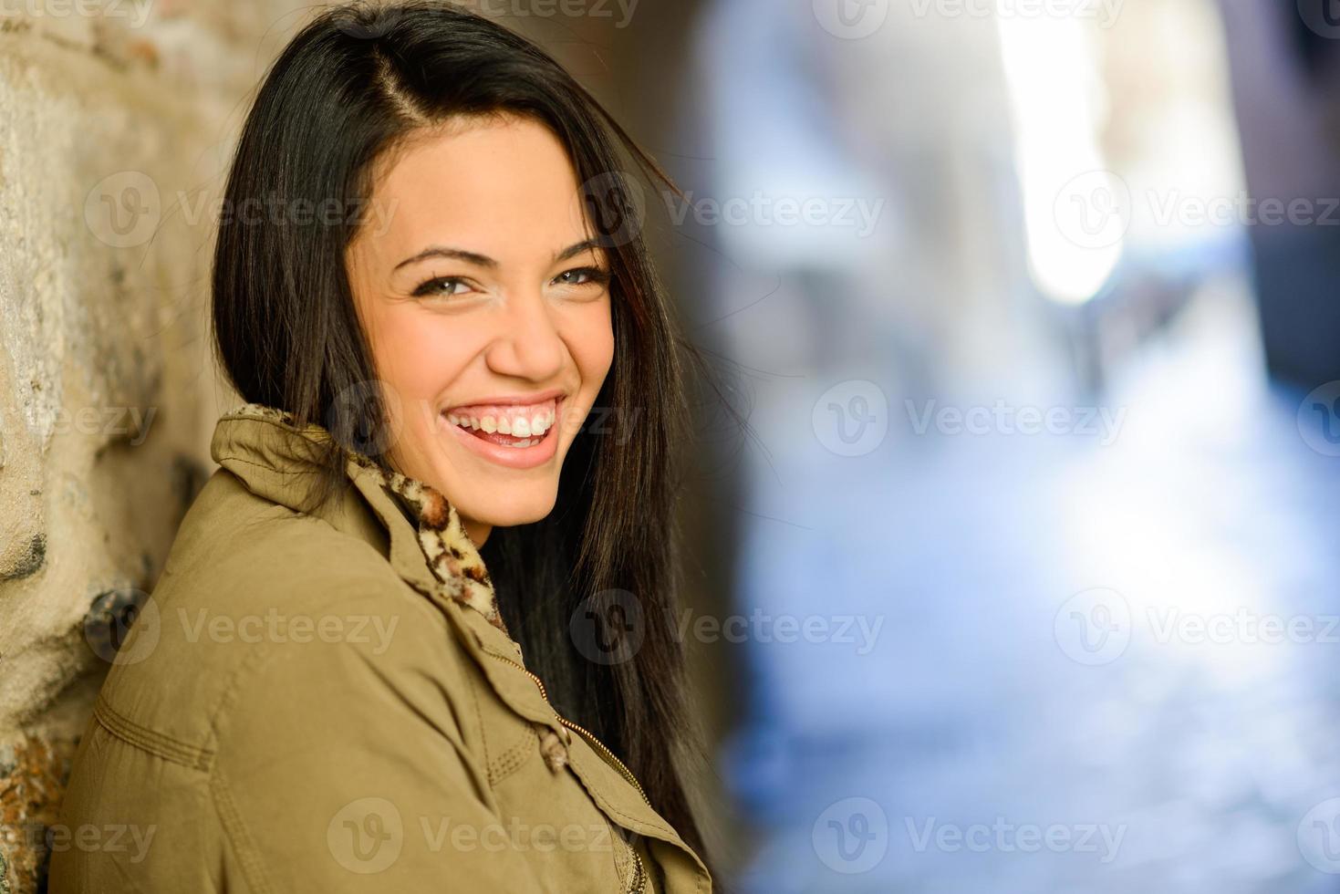 Young woman with green eyes in urban background photo