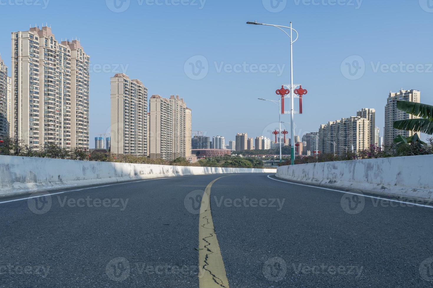 A city road in the front leads to the distance photo