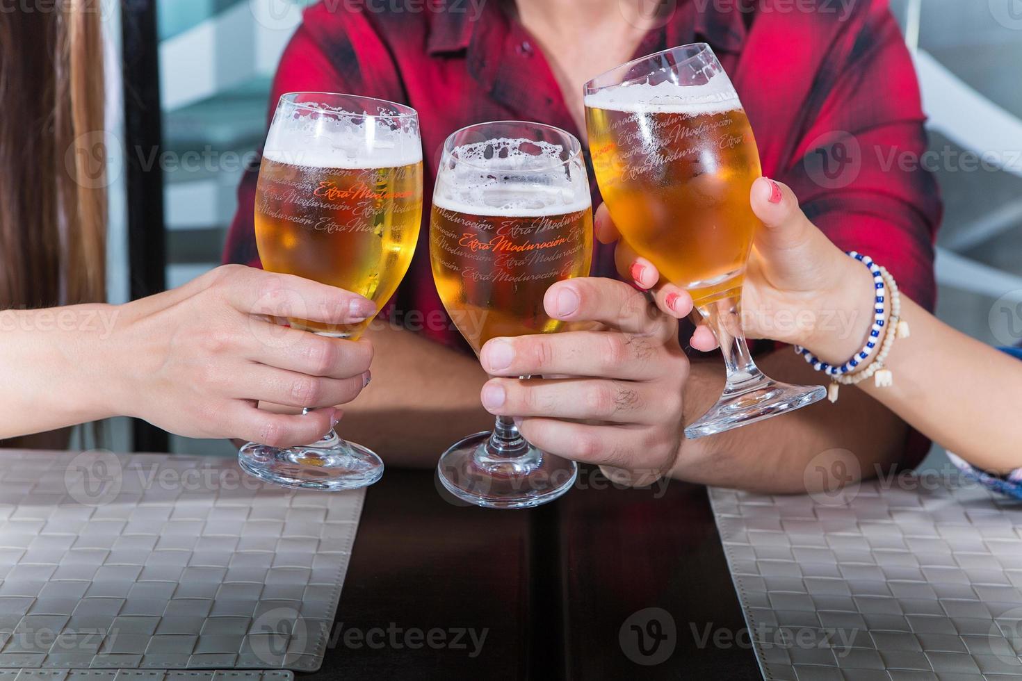 Hands clinking beer photo