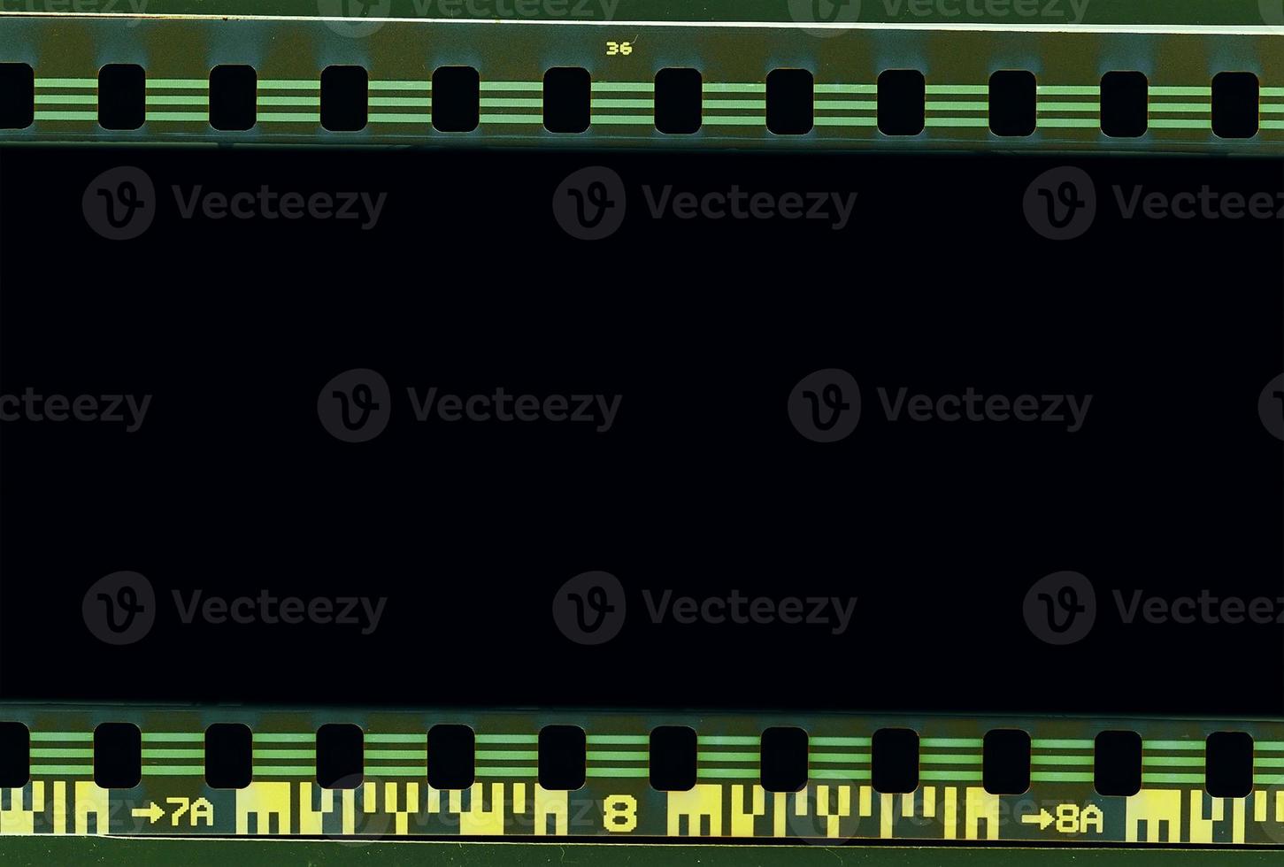 Tira de fotogramas de película de 35 mm escaneada con signos de uso en el bisel. foto