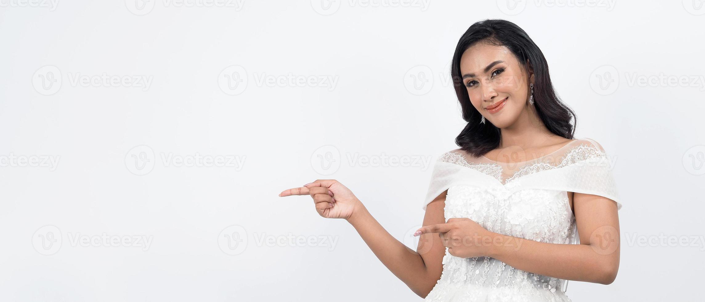 Asian woman in white wedding dress. Thai bride poses before the wedding day. photo