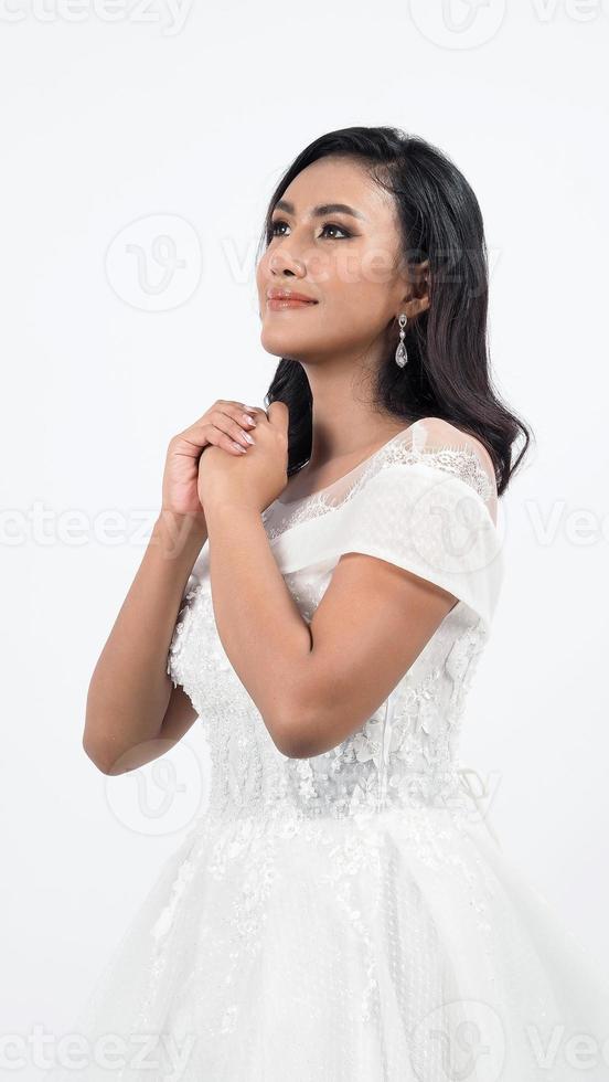 Asian woman in white wedding dress. Thai bride poses before the wedding day. photo