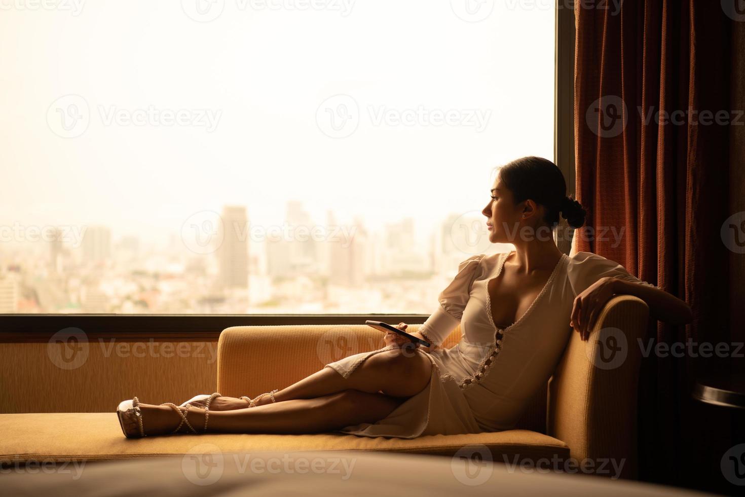 A young businesswoman who travels all over the world to do business. must stay and live in a hotel as a place to relax photo