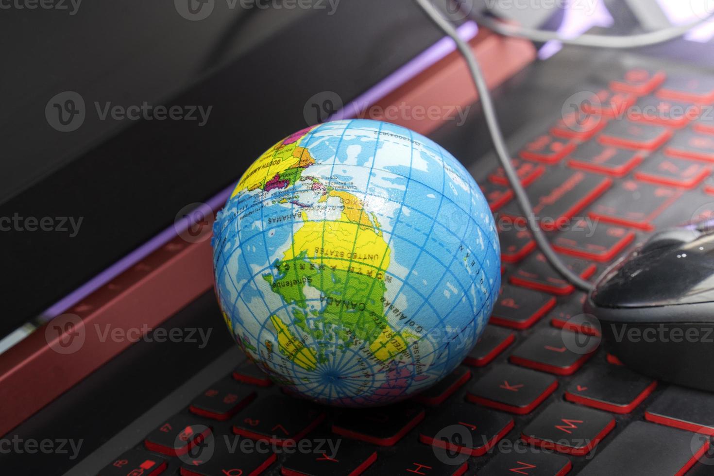 Small globe Placed on a laptop computer. photo