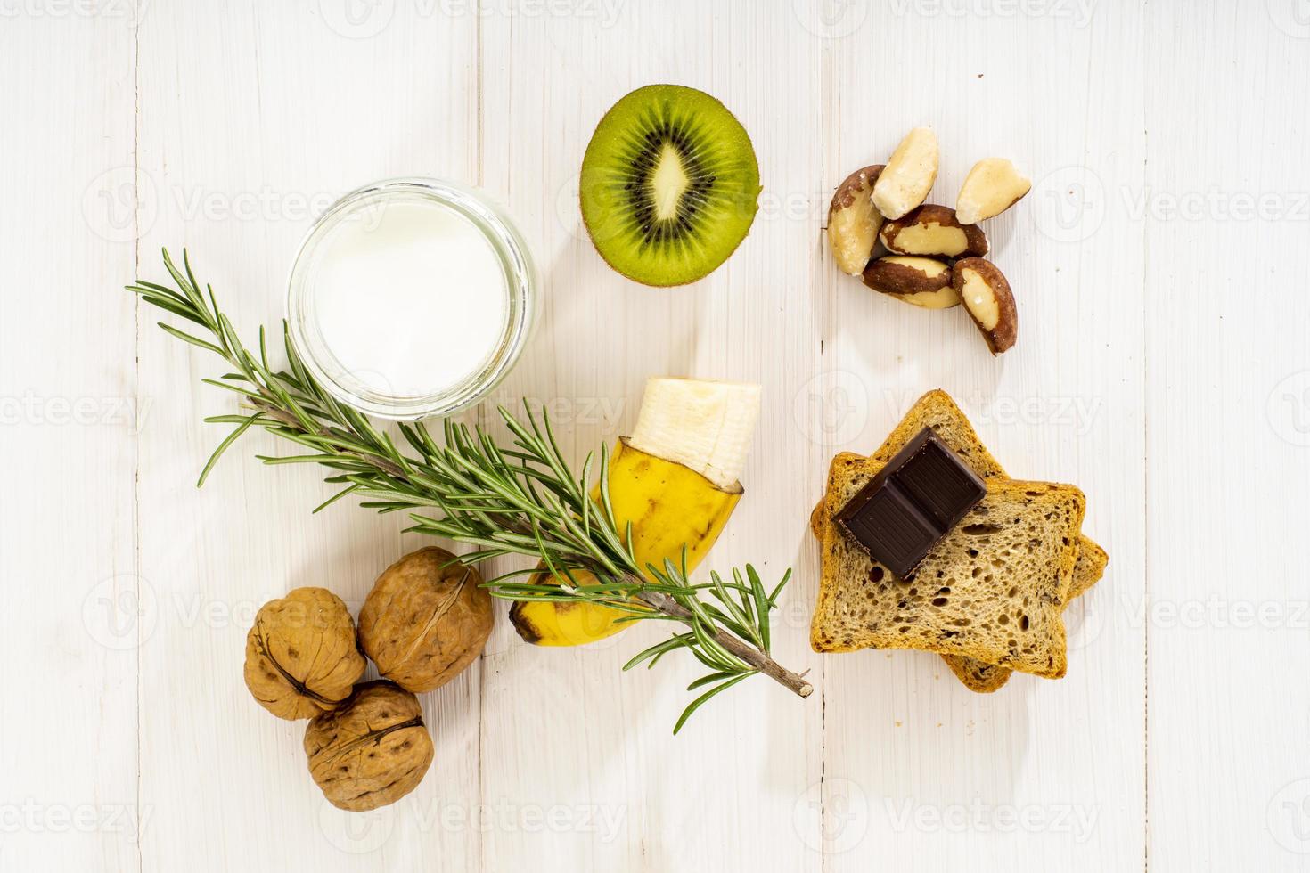 Healthy breakfast Yogurt chocolate banana kiwi and nuts photo