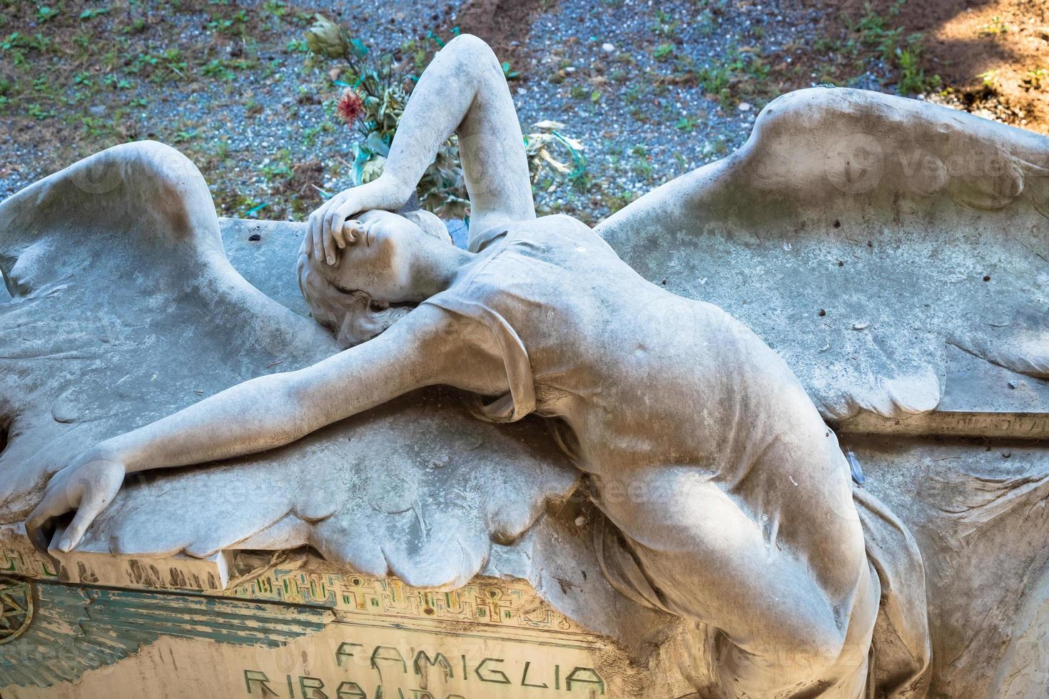 Statue of angel on a 1910 tomb located in an old Italian cemetery photo