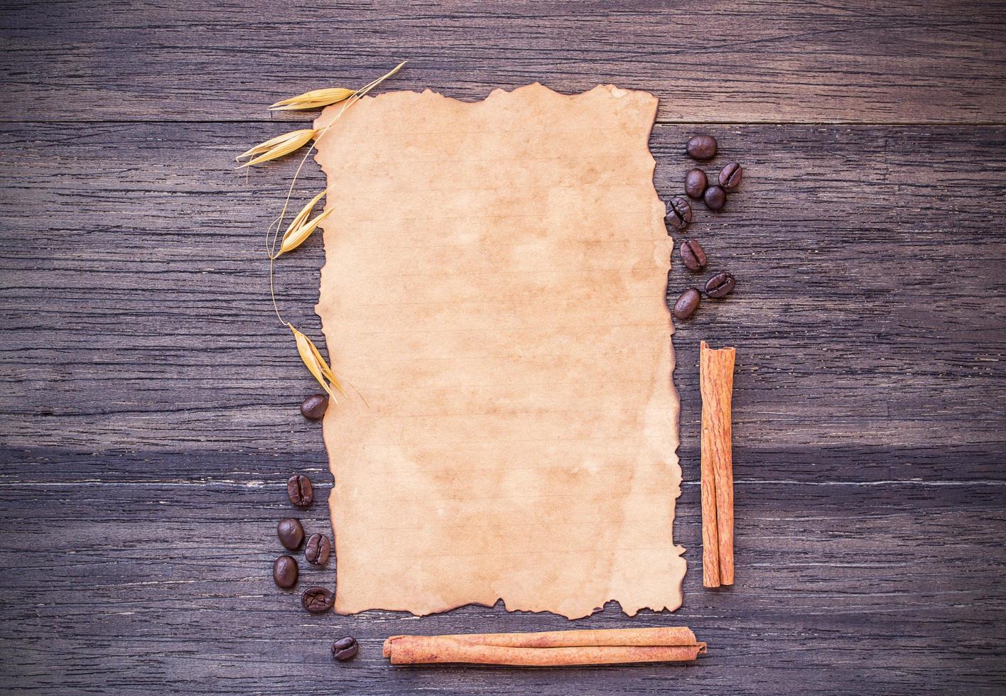 Old paper and coffee beans on dark wooden table background. photo