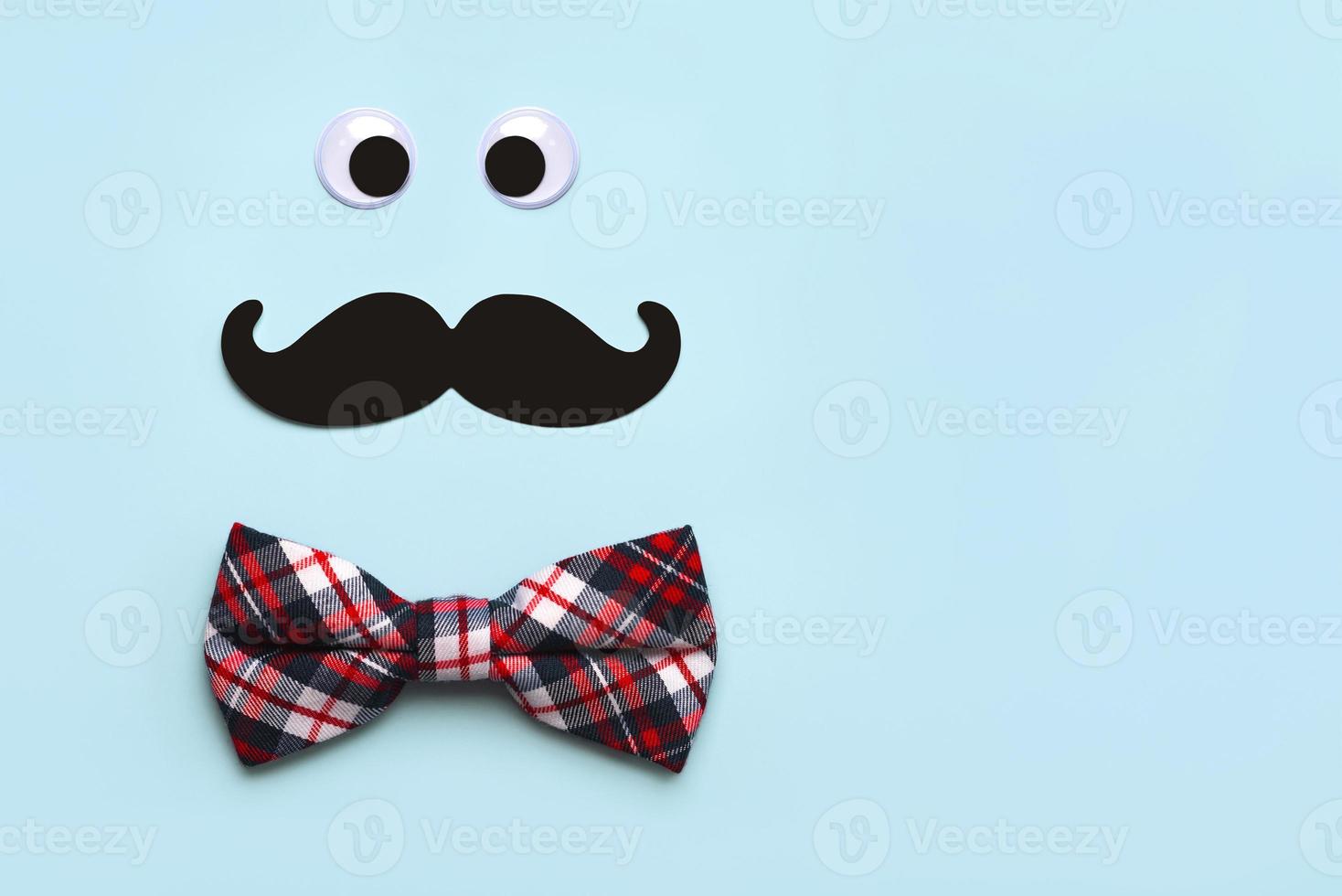 Happy Fathers Day. Top view of false mustache, eyes and bow tie with copy space. Fathers Day celebration concept photo