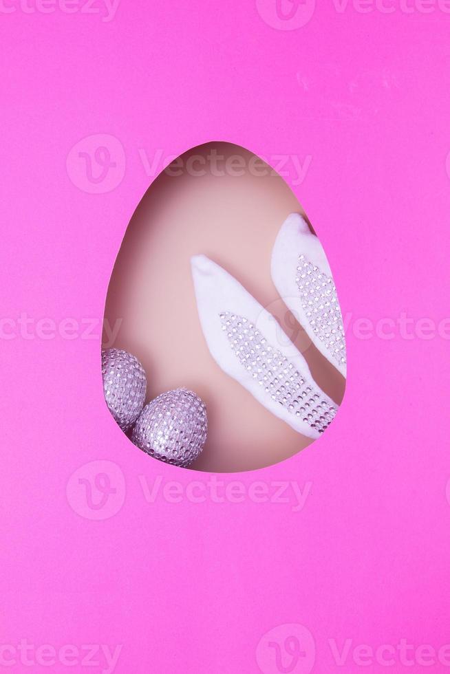 Easter egg cut out of paper and bunny ears with eggs. Easter holiday concept photo
