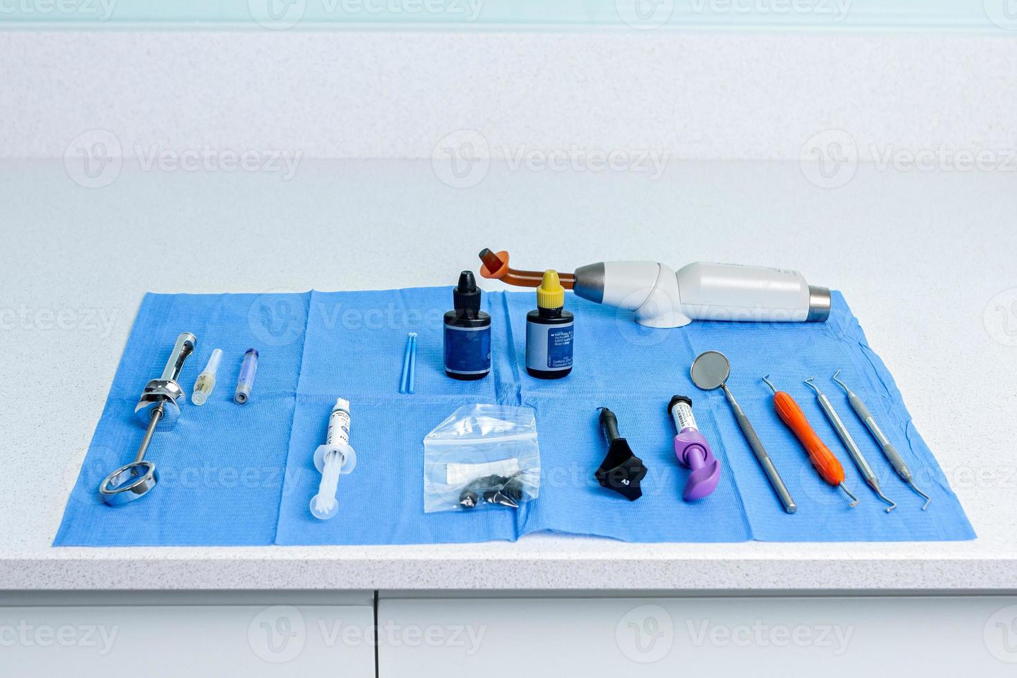Table with a sterile tablecloth with tools for a dentist photo