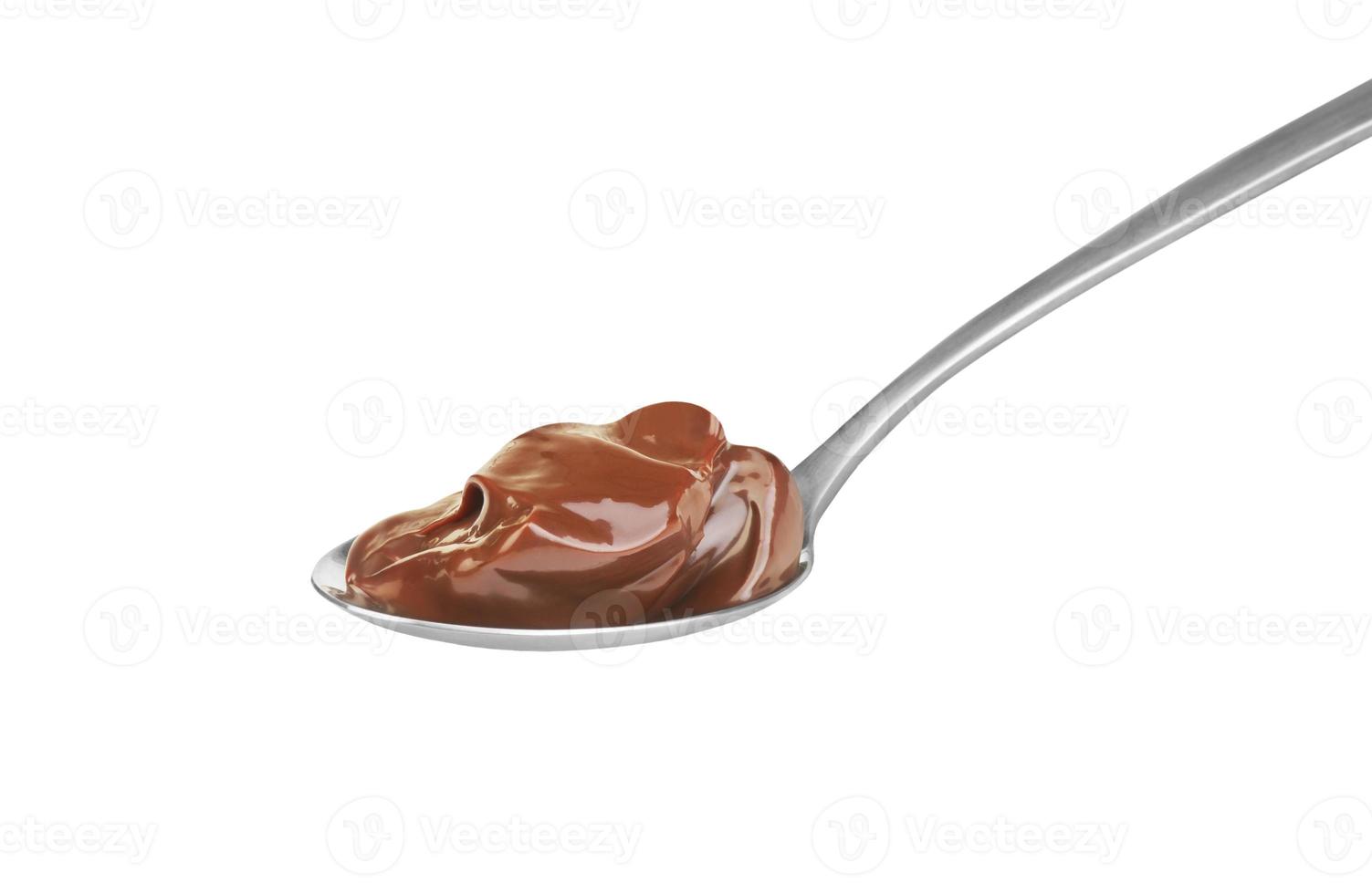 Chocolate cream in spoon on white background photo