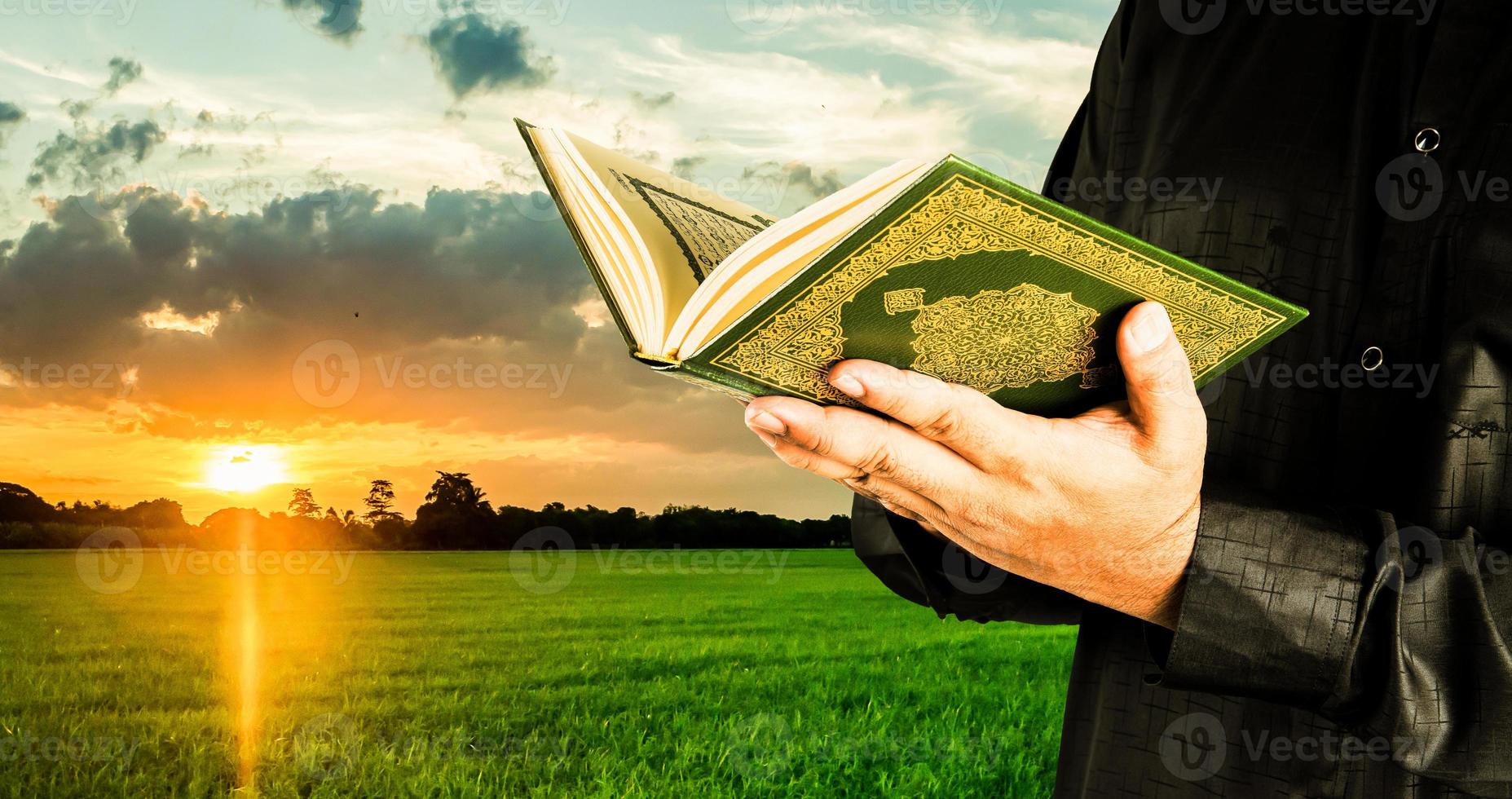 Koran in hand - holy book of Muslims  public item of all muslims photo
