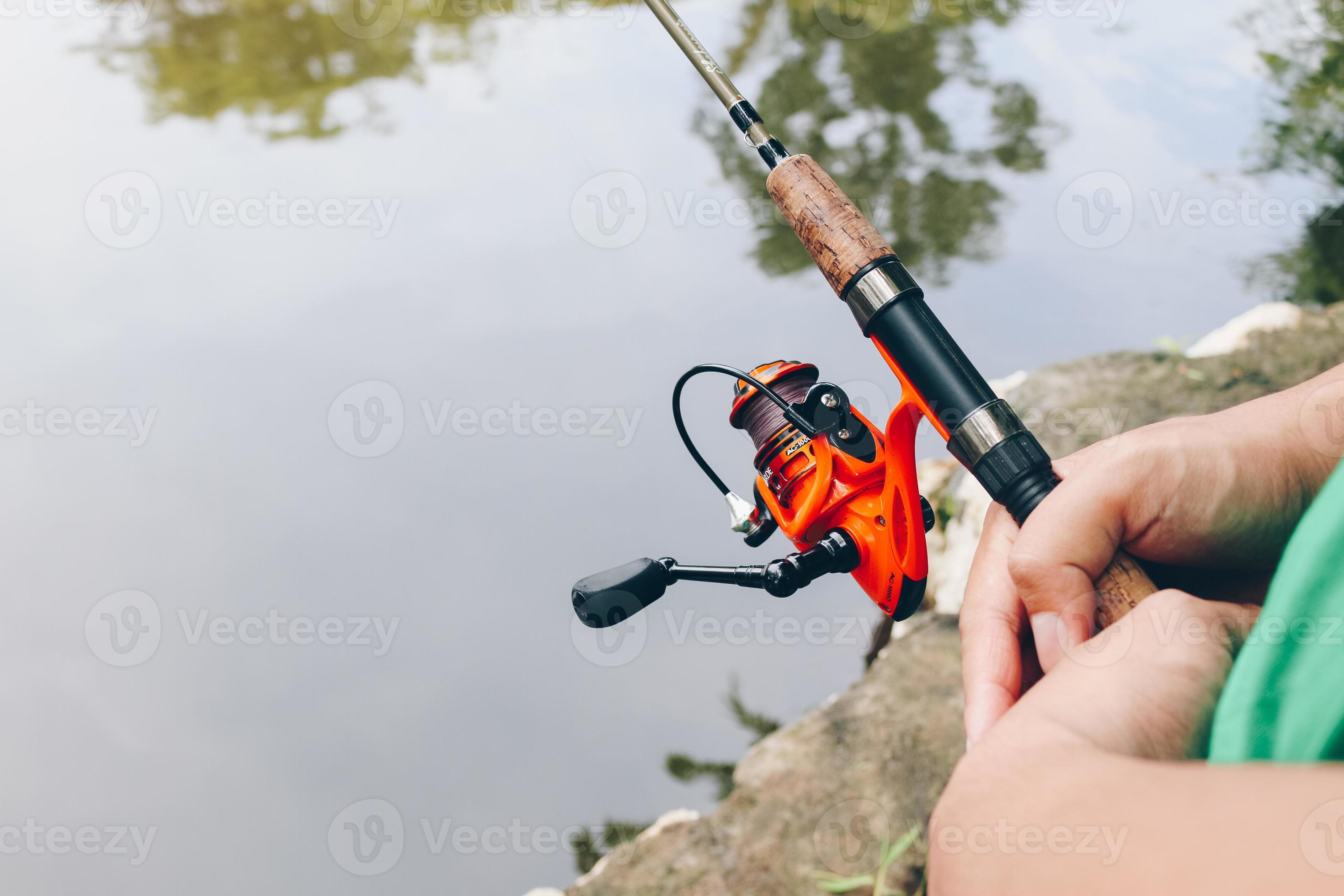 Close up of spinning with the fishing reel in the hand, fishing